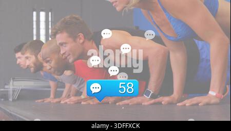 Doing five adults holding push-ups on mat in gym, with blue 58 bubble, wearing sportswear, watches Stock Photo