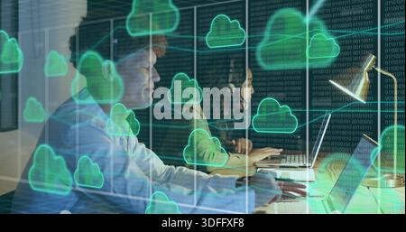 Working two coworkers in business clothes typing on laptops at long desk, headset, lamp, cloud Stock Photo