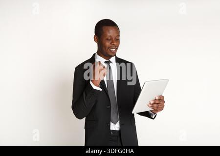 Smiling african american businessman using tablet. Stock Photo