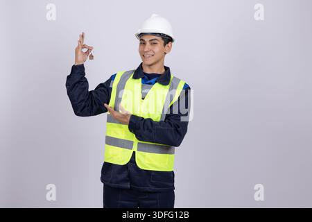 Engineer in safety vest showing thumbs up gesture Stock Photo