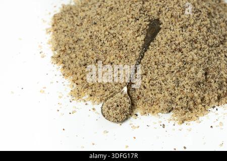 Crushed walnut kernels in spoon close-up on white background Stock Photo