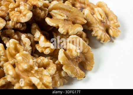 Group of organic walnut halves healthy snack on white background. Stock Photo