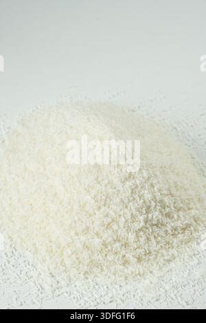 Pile of coconut flakes on white background macro. Stock Photo