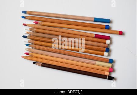 Soft pastel pencils isolated on white, top view. Multicolored pencils on a white background. Art supplies for drawing and graphics. Stock Photo