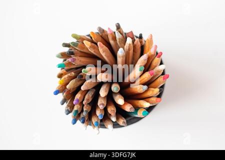 Soft pastel pencils in a black fabric case, top view. A set of multicolored pencils on a white background. Art supplies for drawing and graphics. Stock Photo