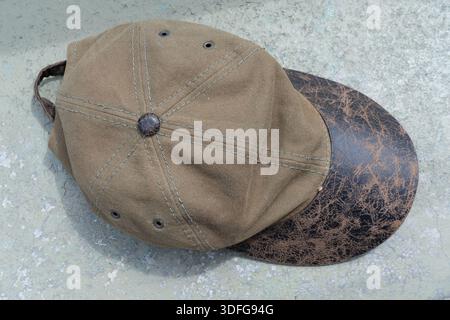 Green cap on a gray cement surface Stock Photo