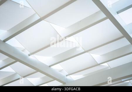 White modern tensile shade structure forming geometric abstract pattern with clean lines and soft diffused light Stock Photo