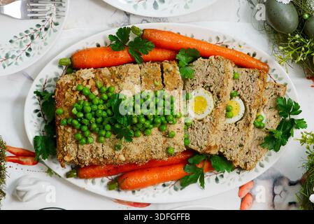 Easter meatloaf with egg, carrots, green beans .top veiw.selective focus Stock Photo