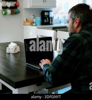 Middle Aged Coder Man Vibe Coding in Artificial Intelligence Infused Integrated Development Environment - Software Engineer Uses AI Based IDE Concept Stock Photo