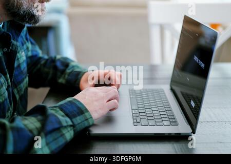 Middle Aged Coder Man Vibe Coding in Artificial Intelligence Infused Integrated Development Environment - Software Engineer Uses AI Based IDE Concept Stock Photo