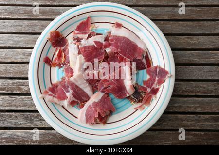 Traditional Spanish Iberian Ham from Jabugo on Cutting Board with Slices and Fat Detail Stock Photo