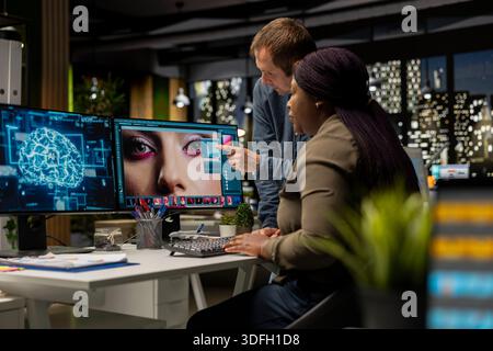 Diverse photo editing team use neural networks for retouching materials, machine learning and editing new photo content online. Professional designers using digital software and AI. Stock Photo