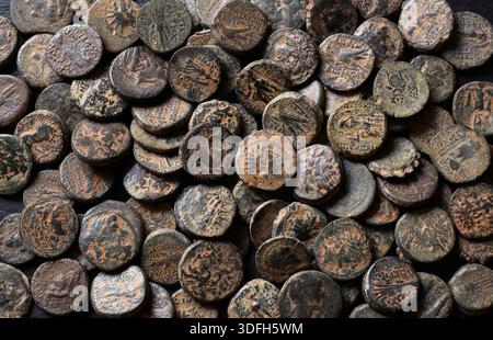 Pile of ancient Greek coins of Seleucid Empire, top view of bronze money, vintage texture background, concept of antique hoard Stock Photo