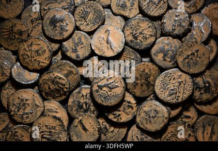 Ancient Greek coins of Seleucid Empire, top view of pile of bronze money, vintage background, concept of antique, texture and history Stock Photo
