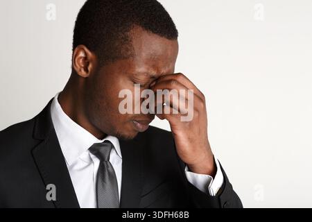 Depressed businessman having headache closeup Stock Photo