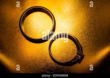 Wedding Rings on Golden Textured Background Stock Photo