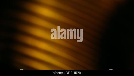 Line light blur. Flash leak texture. Yellow brown corrugated optical effect on dark black background. Color abstract illumination free space. Stock Photo