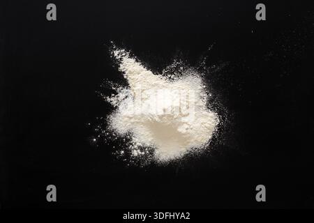 Flour Powder Spread out on a Black Surface During Cooking Preparation in a Home Kitchen Stock Photo