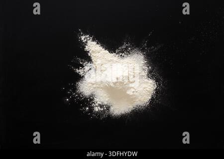 Sprinkled wheat flour splash spots on black background Stock Photo