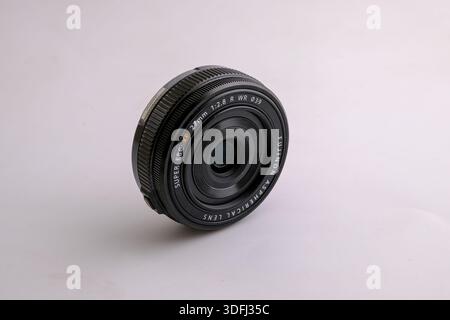 A close-up view of a camera lens on a light background Stock Photo