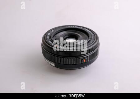 A close-up view of a camera lens on a white background Stock Photo