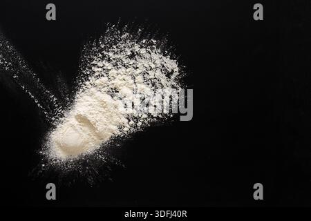Flour Spread out on a Dark Surface With a Unique Texture and Shape Stock Photo