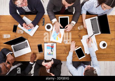 Business meeting. Multiethnic. Worker, development strategy, in office, top view of wooden table Stock Photo