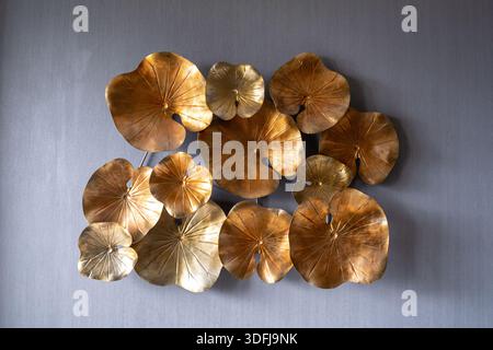 Luxury wall art decoration featuring golden lotus leaves on a grey textured background Stock Photo