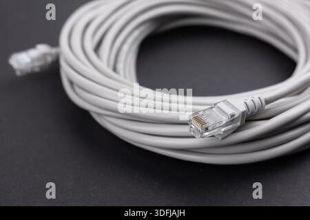 network cable, isolated on white background. Closeup LAN cables with connector. Lan cable for internet network connection, gray lan cable on a white b Stock Photo