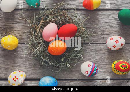 Colorful Easter Eggs Arranged in a Nest on a Rustic Wooden Table in Spring Season Stock Photo