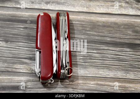 Two multi-tool pocket army knifes, a compact, folding device that combines multiple functions (tools) into a single, portable unit, screwdriver, can o Stock Photo