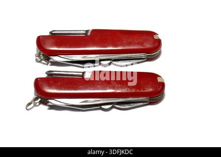 Two multi-tool pocket army knifes, a compact, folding device that combines multiple functions (tools) into a single, portable unit, screwdriver, can o Stock Photo