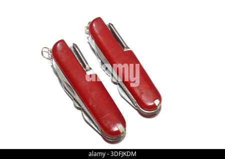 Two multi-tool pocket army knifes, a compact, folding device that combines multiple functions (tools) into a single, portable unit, screwdriver, can o Stock Photo