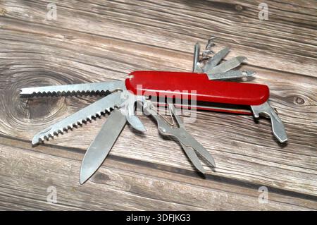 A multi-tool pocket army knife, a compact, folding device that combines multiple functions (tools) into a single, portable unit, screwdriver, can open Stock Photo
