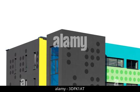 Modern colorful building with bright geometric facade in black, yellow, turquoise, and green tones, decorated with circular patterns. Contemporary arc Stock Photo