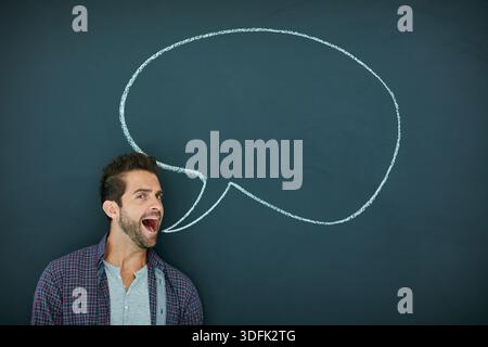Man, speech bubble and talk in portrait, chalkboard and mockup space for opinion, icon or social media. Person, voice and announcement with review Stock Photo