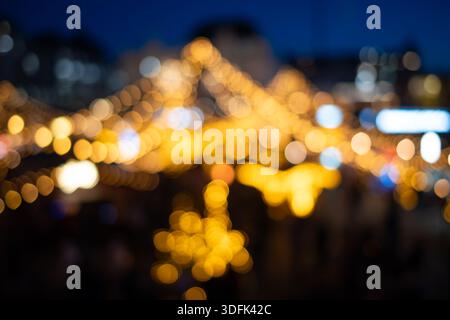 Blurry Christmas market hanging light decorations.  Defocused, bokeh balls background, abstract background, no people Stock Photo