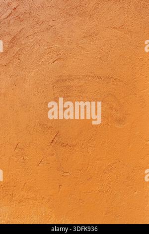 Texture of an old orange plastered wall. Abstract construction background. Stock Photo