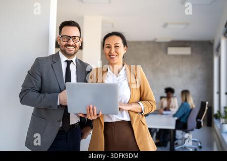 Mixed team of software engineers brainstorming ideas. Diverse app developers collaborating as group Stock Photo