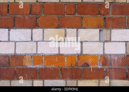 The old wall is unevenly painted. Abstract construction background. Stock Photo