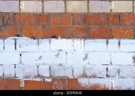 The old wall is unevenly painted. Abstract construction background. Stock Photo