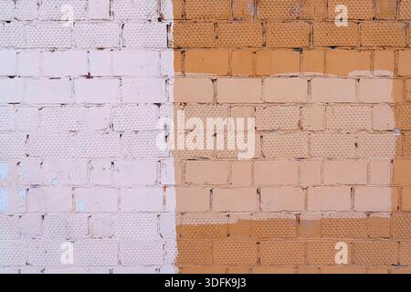 The old wall is unevenly painted. Abstract construction background. Stock Photo