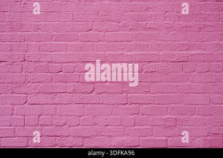 The brick wall is painted with pink paint. Abstract construction background. Stock Photo