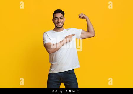 Athletic middle eastern man showing his muscles Stock Photo