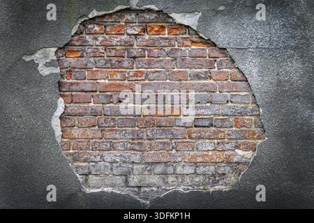 Rustic red corroded brick hole in a grey plaster wall. High quality texture and background for your projects and creative work Stock Photo