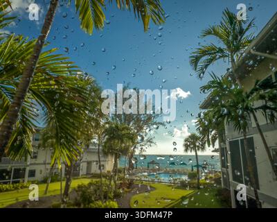 Grand Cayman, Cayman Islands, May 25th 2023, view of rain drops on a window facing the Caribbean Sea Stock Photo