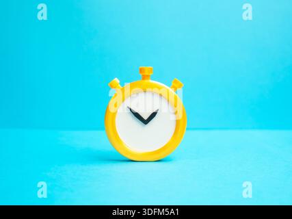 Stopwatch on a blue background. Concept of time and countdown. Deadlines and terms. Visual metaphor of urgency, time management pressure and limited r Stock Photo