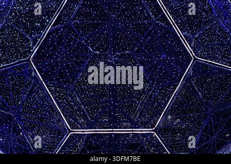 Festive illumination of various geometric shapes from a variety of blue LED lamps. Stock Photo