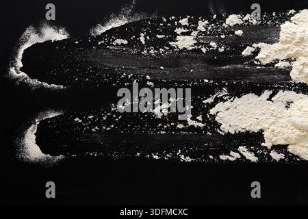 Sprinkled wheat flour splash spots on black background Stock Photo