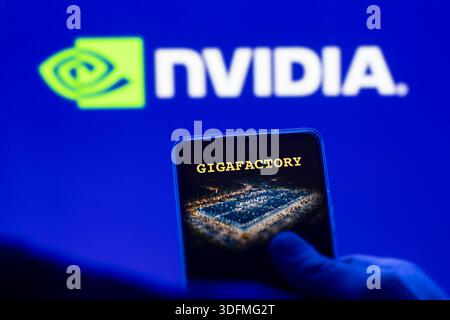 Gigafactory plan, the logo of Nvidia on the blurred background. Stock Photo